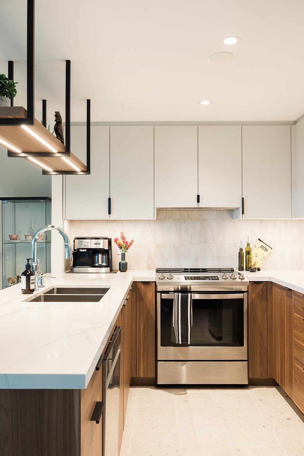 View of oven and sink in GTA condo kitchen renovation with flat panel two tone cabinets by Golden Bee Condos