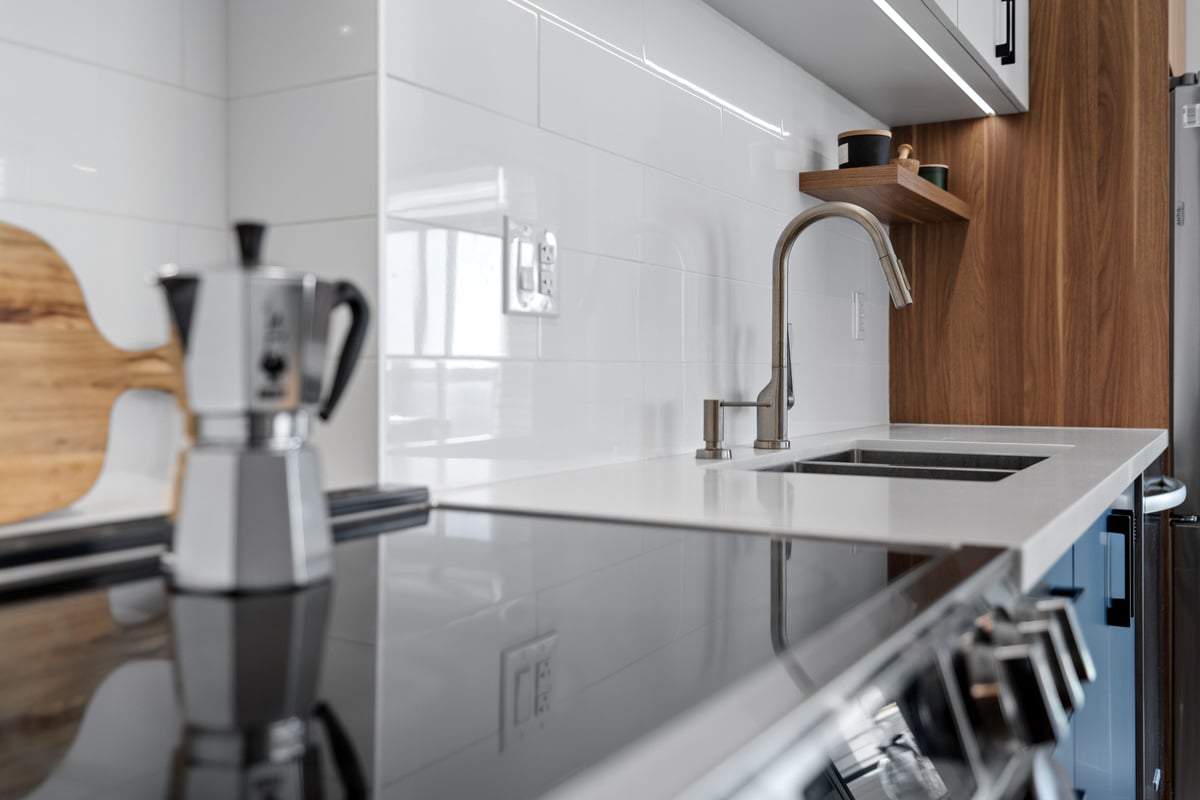 Up-close view of oven and countertop in GTA condo kitchen renovation with white backsplash