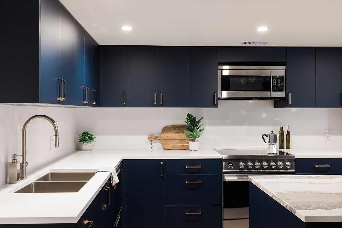 Luxury downtown Toronto condo renovation Dark blue kitchen cabinets by Golden Bee Condos