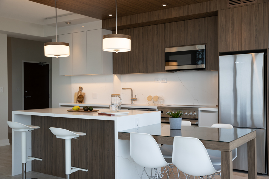 Condo kitchen with island and flat panel modern cabinets in downtown Toronto by Golden Bee Condos