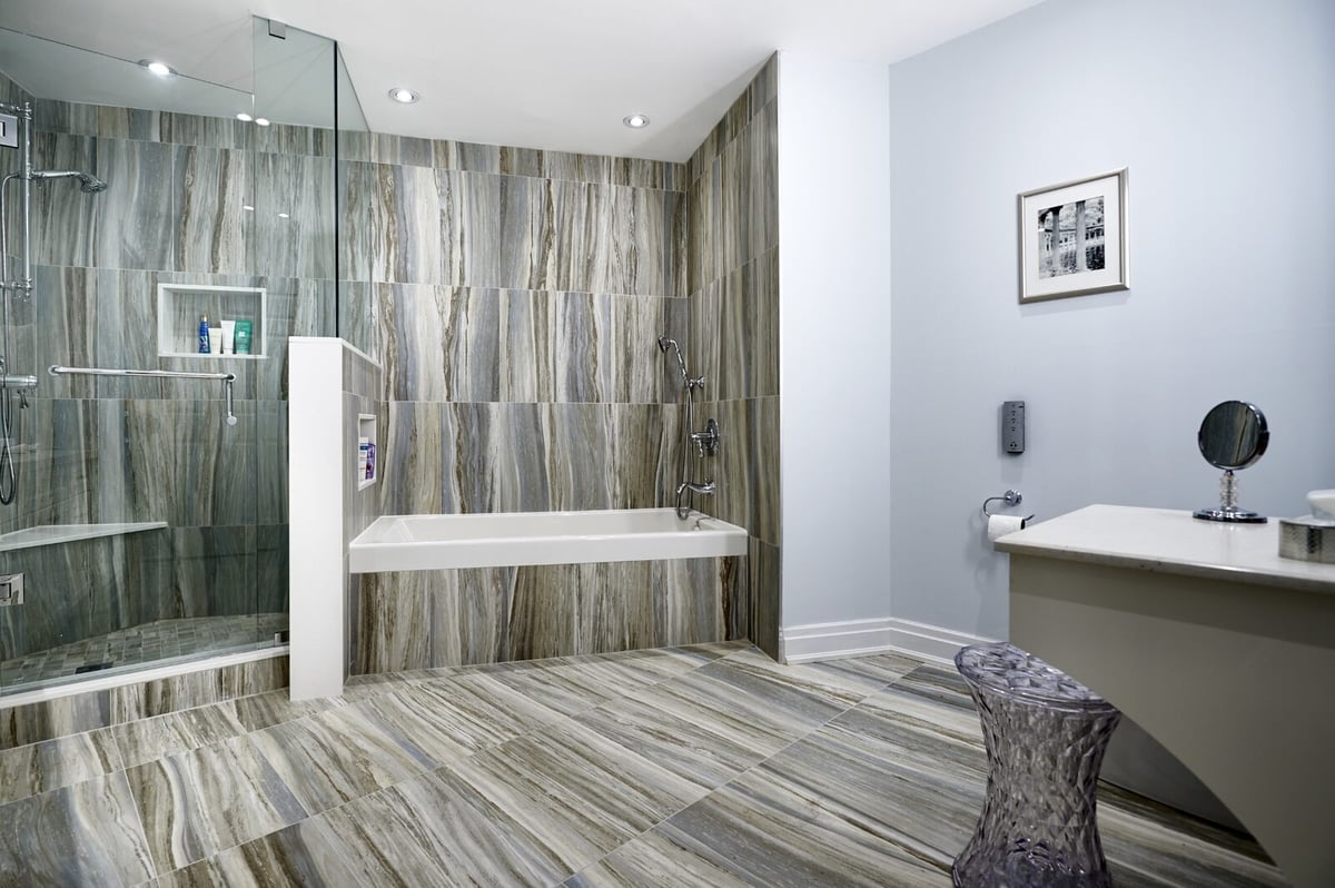 Gray large format tiling with bathtub in bathroom renovation condo in Toronto