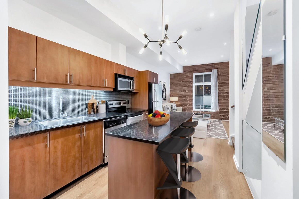 Pendant lighting above kitchen island in kitchen condo renovation in Toronto