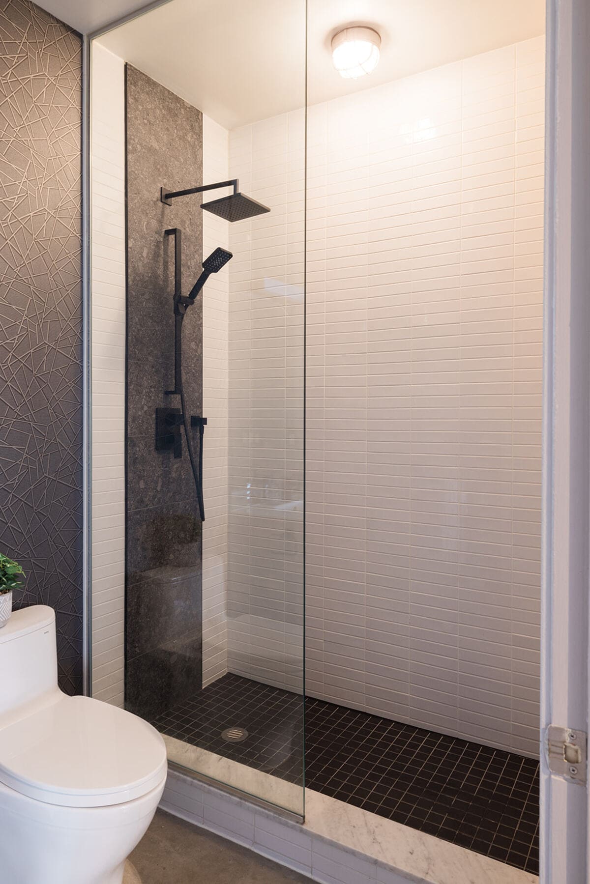 Walk-in shower in luxury condo bathroom renovation by Golden Bee Condos 