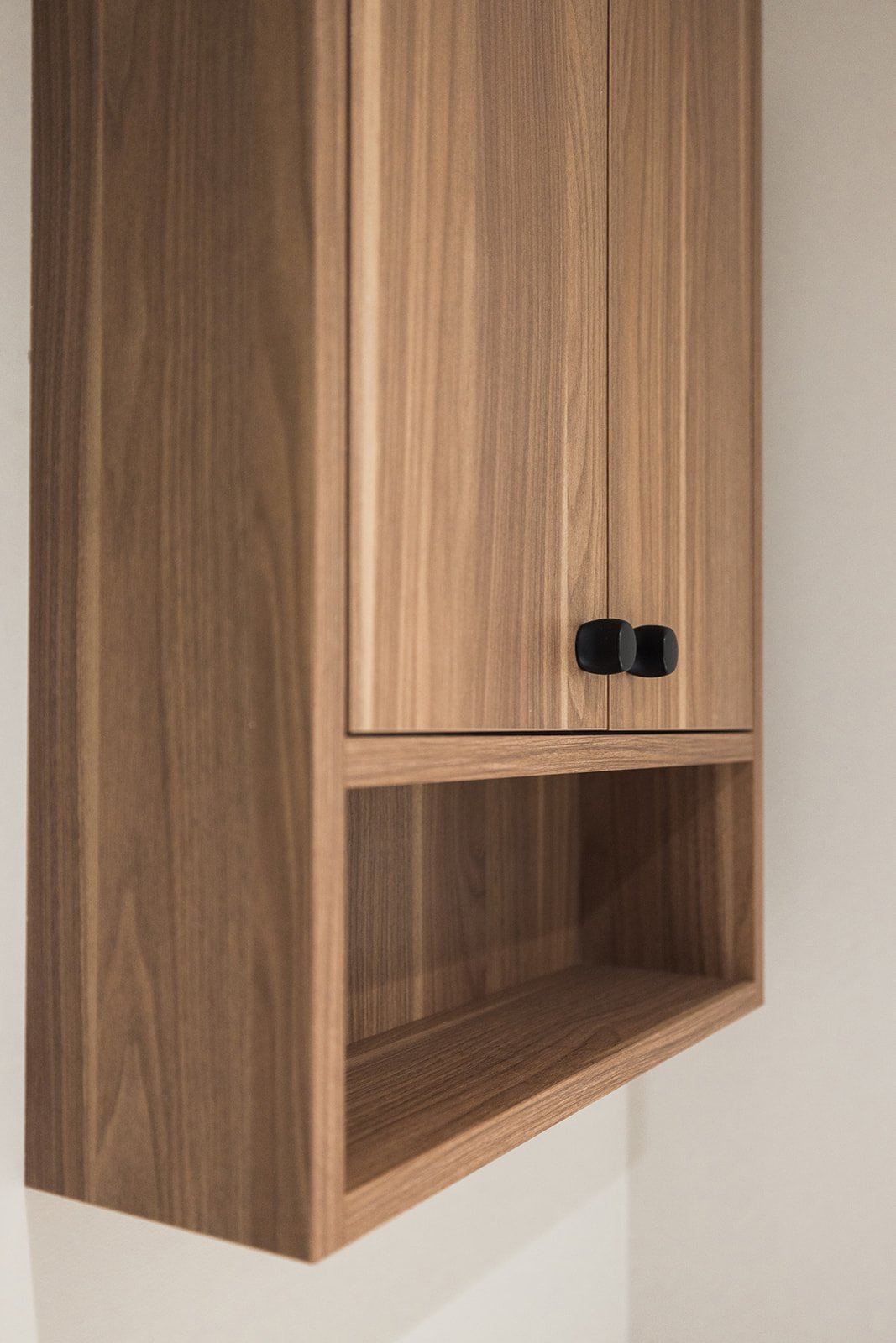 Details of wood flat-panel cabinet with black knob pulls in Toronto