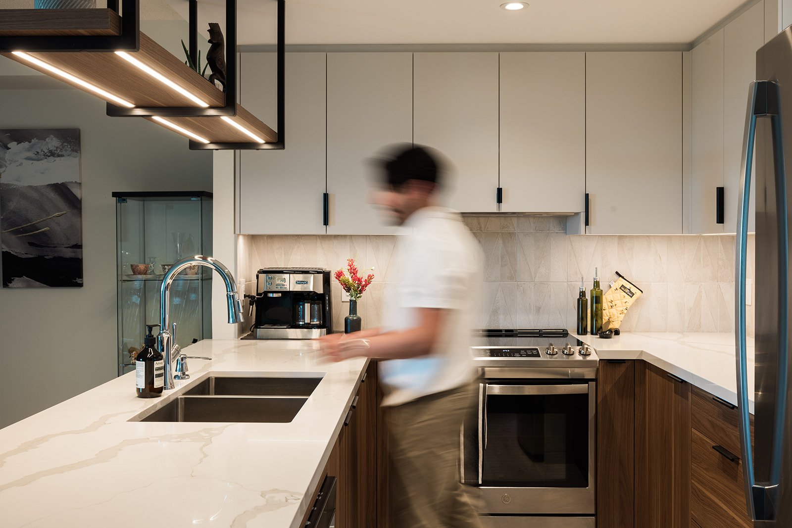 Man at sink in new luxury condo kitchen by Golden Bee Condos