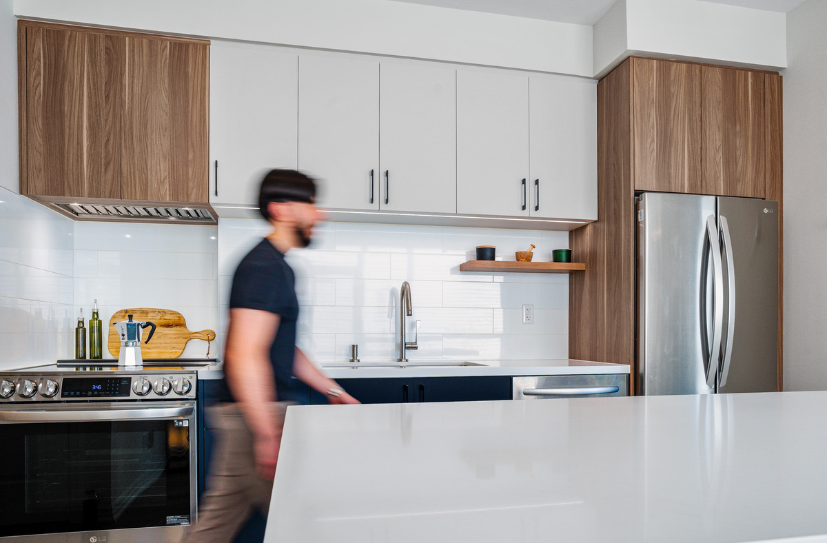 Man walking in renovated condo kitchen in downtown Toronto