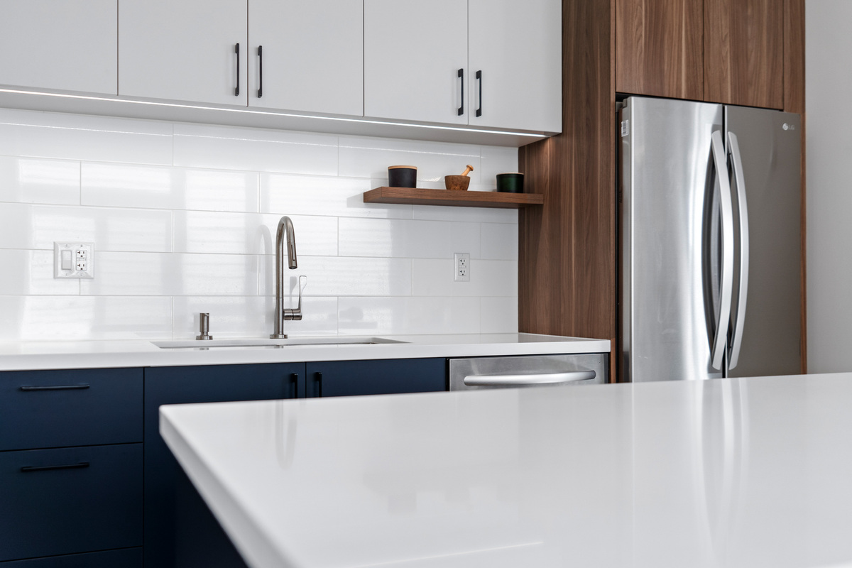 White countertop in GTA condo kitchen renovation with white backsplash