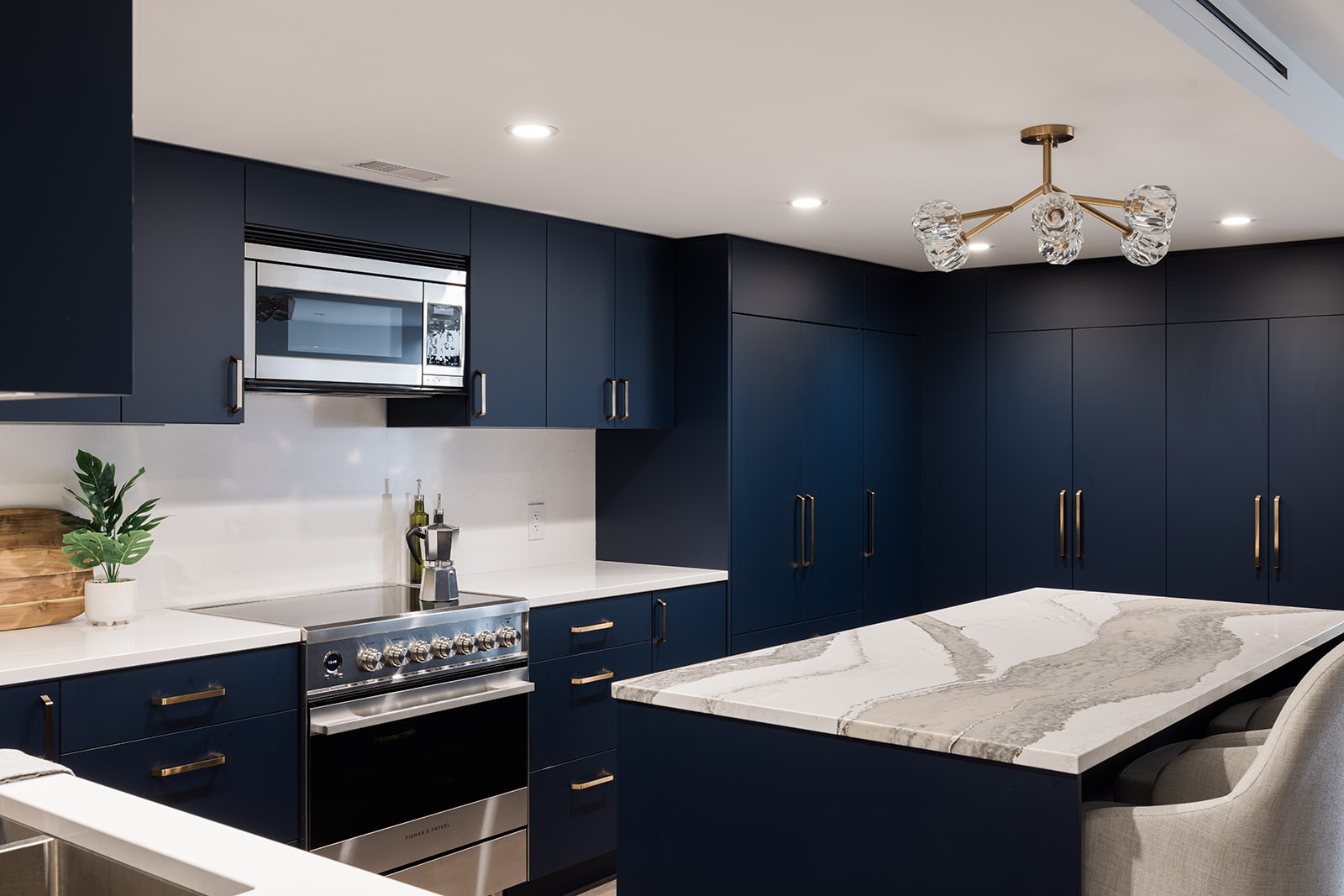 Dark blue flat panel cabinets and island in downtown Toronto luxury condo kitchen renovation