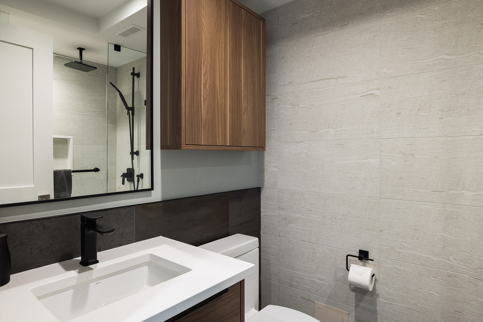 Downtown Toronto condo bathroom renovation with built-in storage above toilet and white vanity top