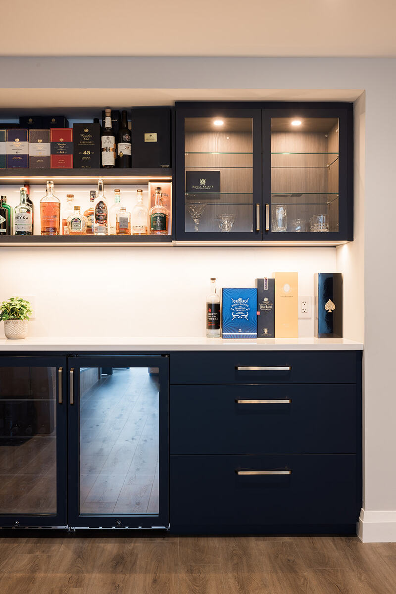 Downtown Toronto condo renovation shot of custom beverage station with wine fridge, under-cabinet lighting, and built-in shelving by Golden Bee Condos