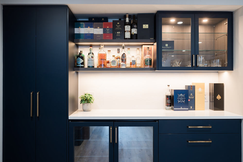 Downtown Toronto full condo renovation view of custom beverage station with dark blue flat panel cabinetry