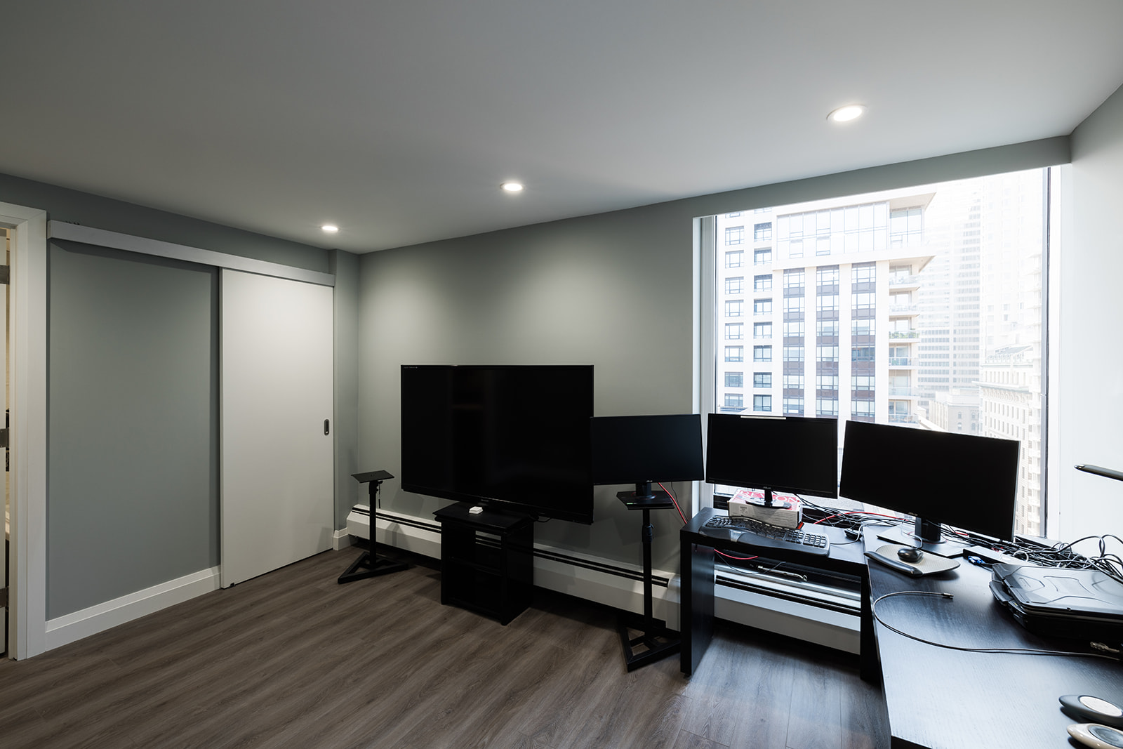 Flex room in downtown Toronto full condo renovation with recessed lighting and large window