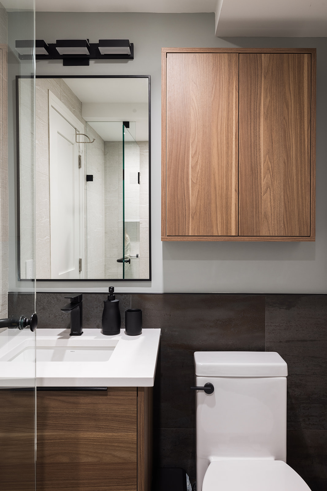 Luxury condo bathroom renovation in downtown Toronto with wood flat panel storage