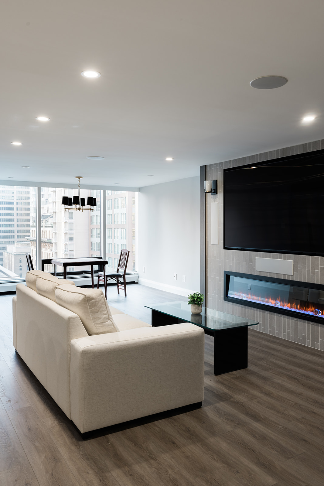 Luxury downtown Toronto condo renovation living room space with floor-to-ceiling windows and recessed lighting by Golden Bee Condos