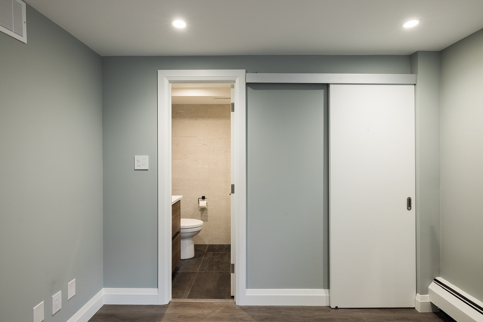 Luxury full condo renovation in downtown Toronto with door open to bathroom
