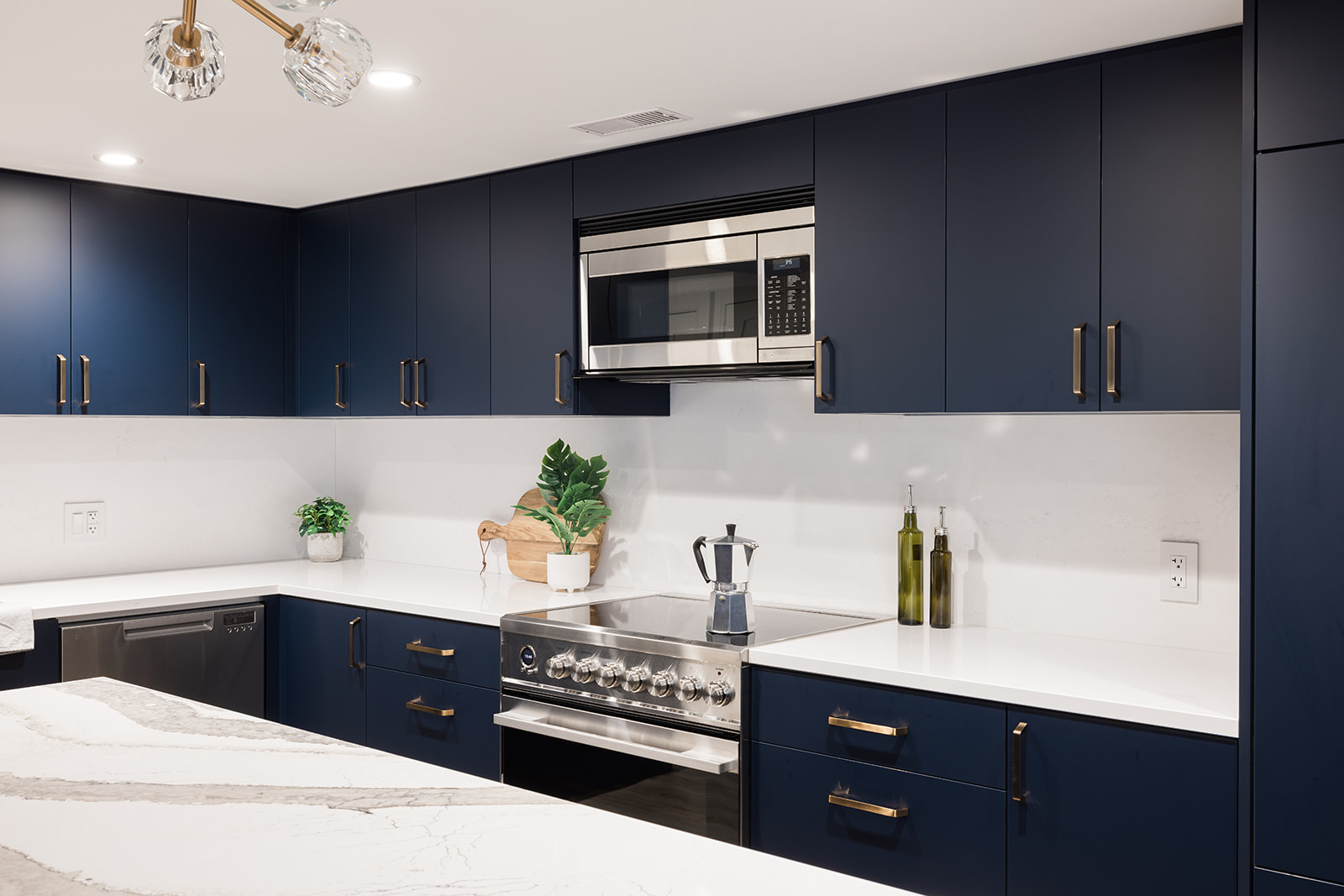 Microwave and oven in downtown Toronto luxury kitchen condo renovation with dark blue cabinets
