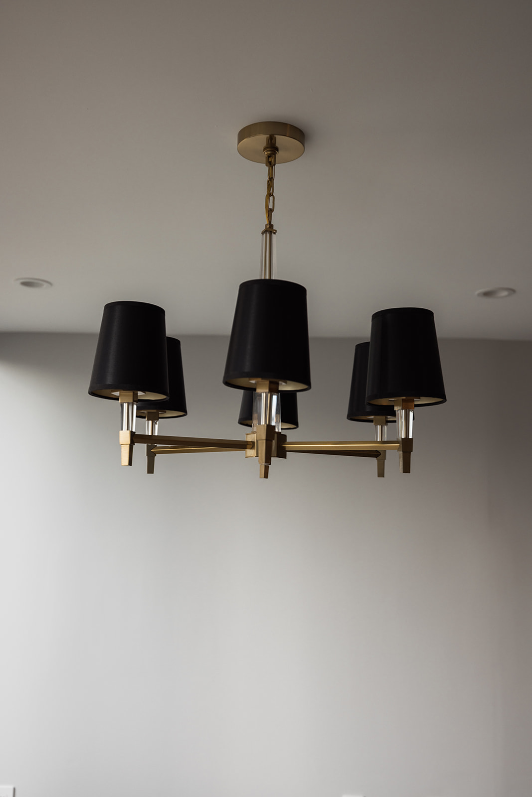 Shot of hanging light fixture with black shades in downtown Toronto condo renovation
