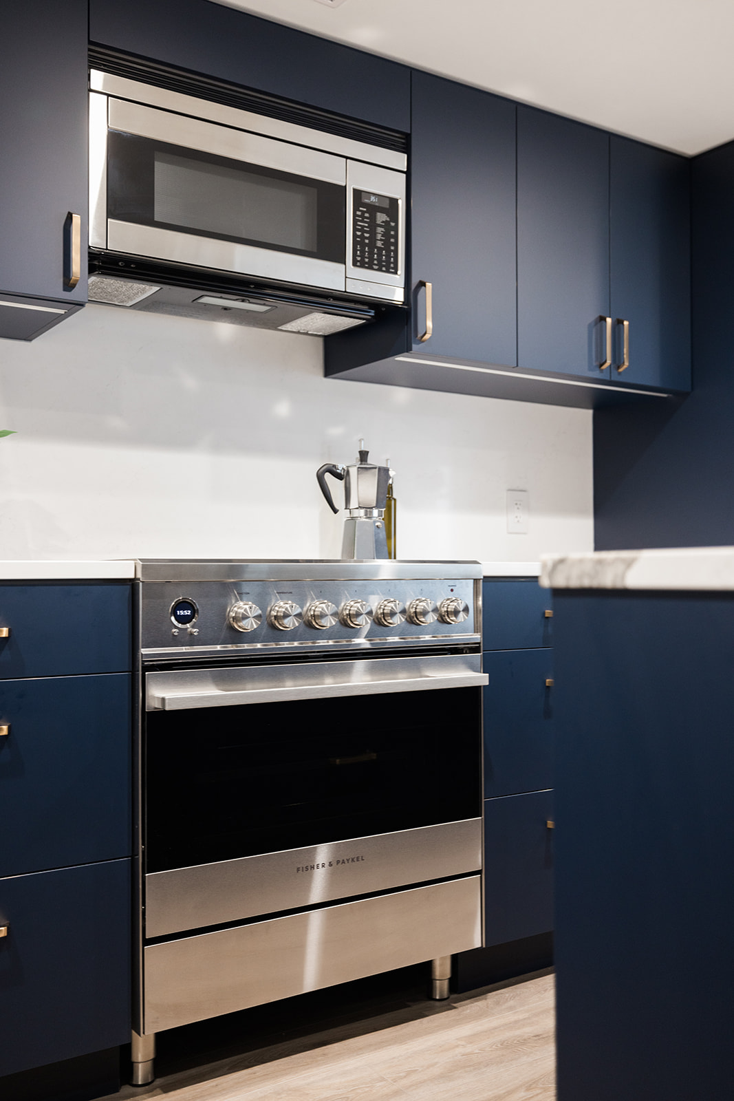 Stainless steel microwave and oven in luxury condo kitchen renovation in Toronto