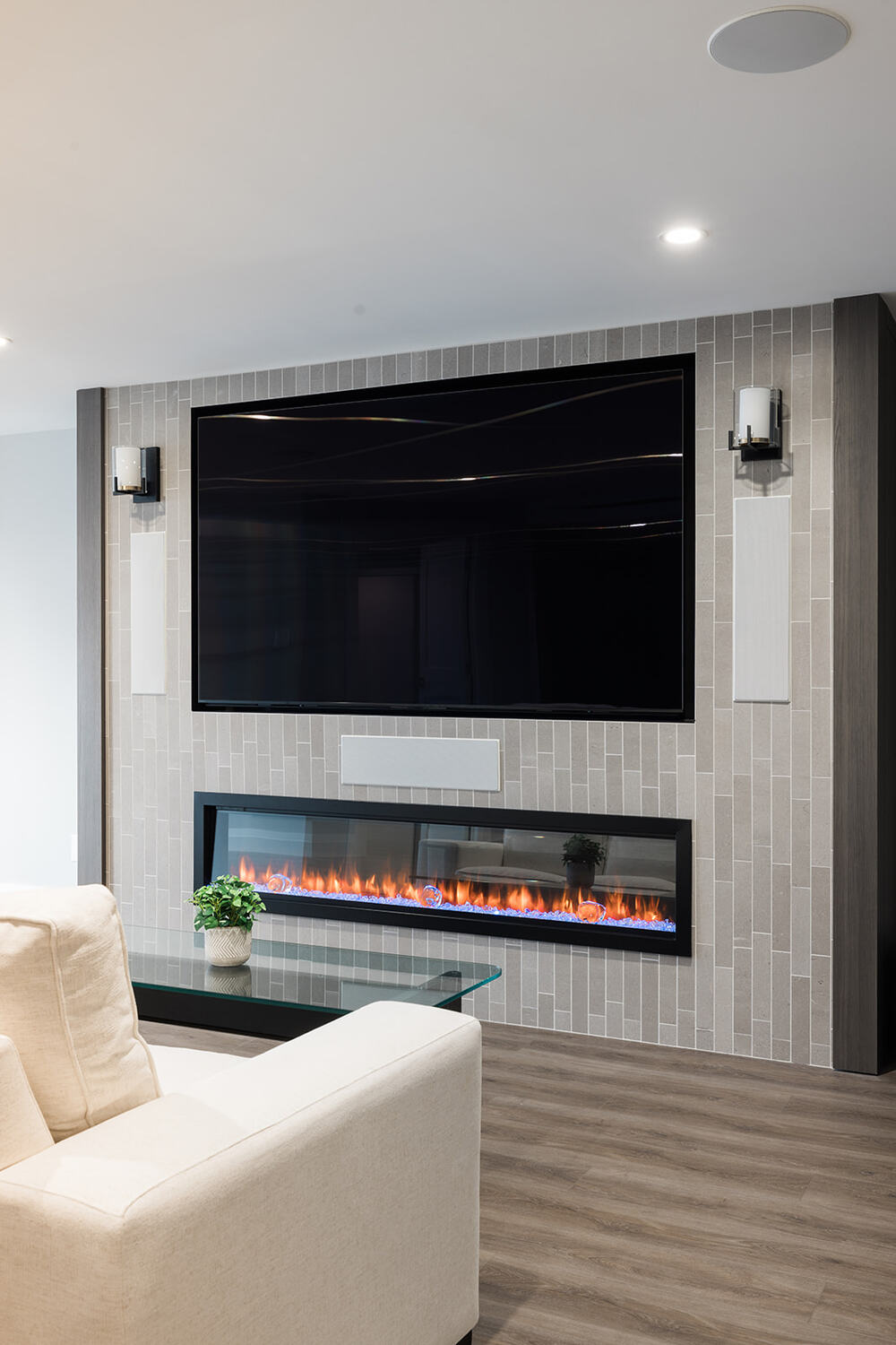 View of custom fireplace in living room in downtown Toronto condo renovation with LVP flooring