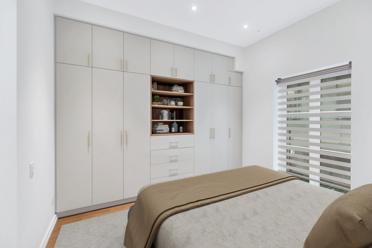 Floor-to-ceiling custom storage with flat panel doors and open shelving in Toronto condo bedroom