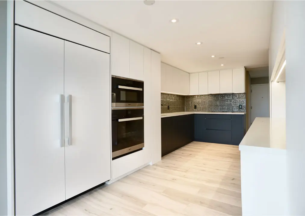Modern condo kitchen renovation in Toronto with white flat panel cabinetry
