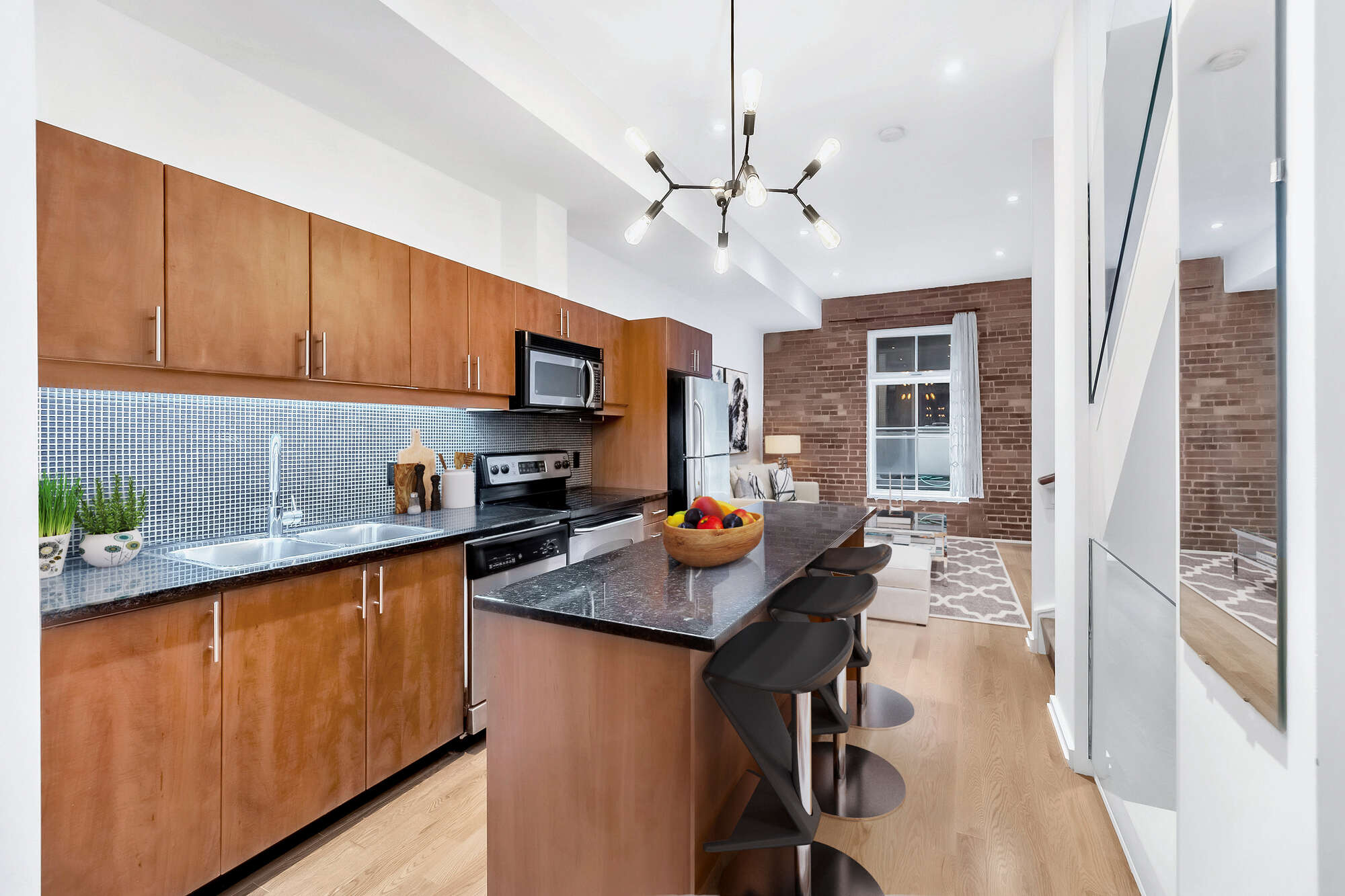Kitchen condo renovation with island and bar stools in Toronto