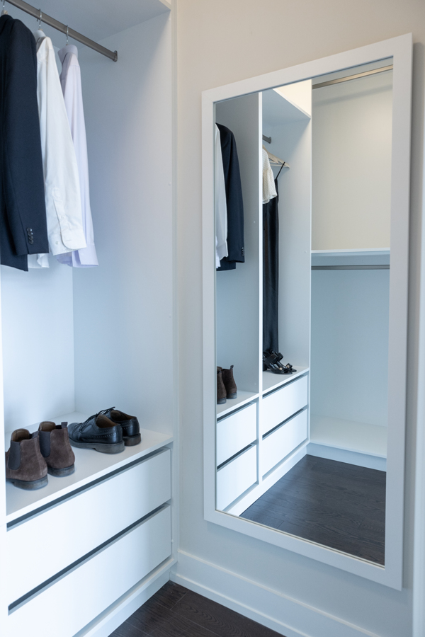 Walk-in condo closet with built-in vertical storage and shoe organization